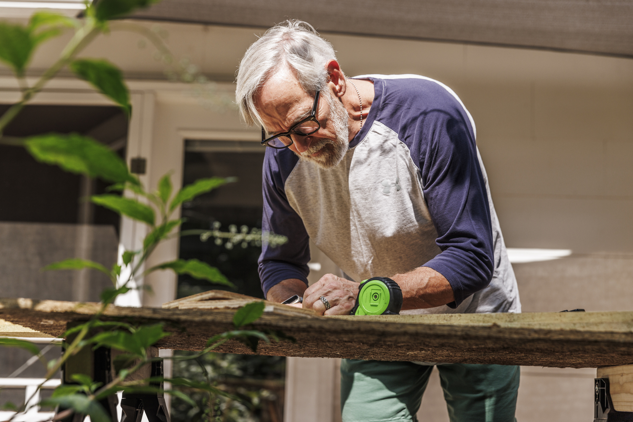 Older adult working on his home