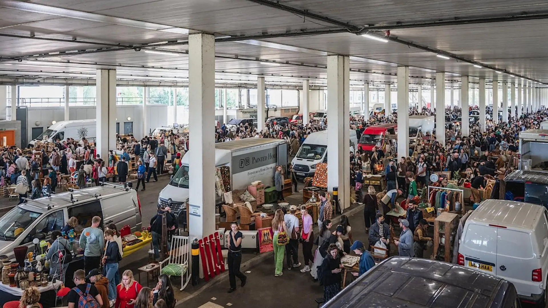 London Giant London Flea Market - people walking around vans in a car park looking at things to buy 