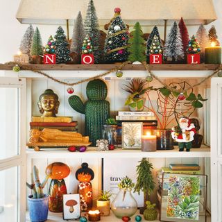shelving with Christmas tree decorations including Noel lettering, Christmas tree, Santa statue