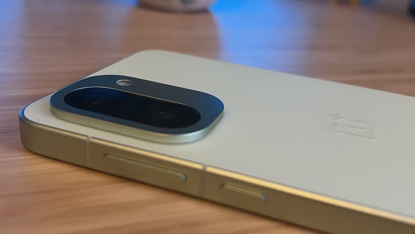 OnePlus 15R phone on a wooden desk