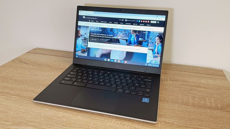 Samsung Galaxy Chromebook Go review: woman holding chromebook talking to a man