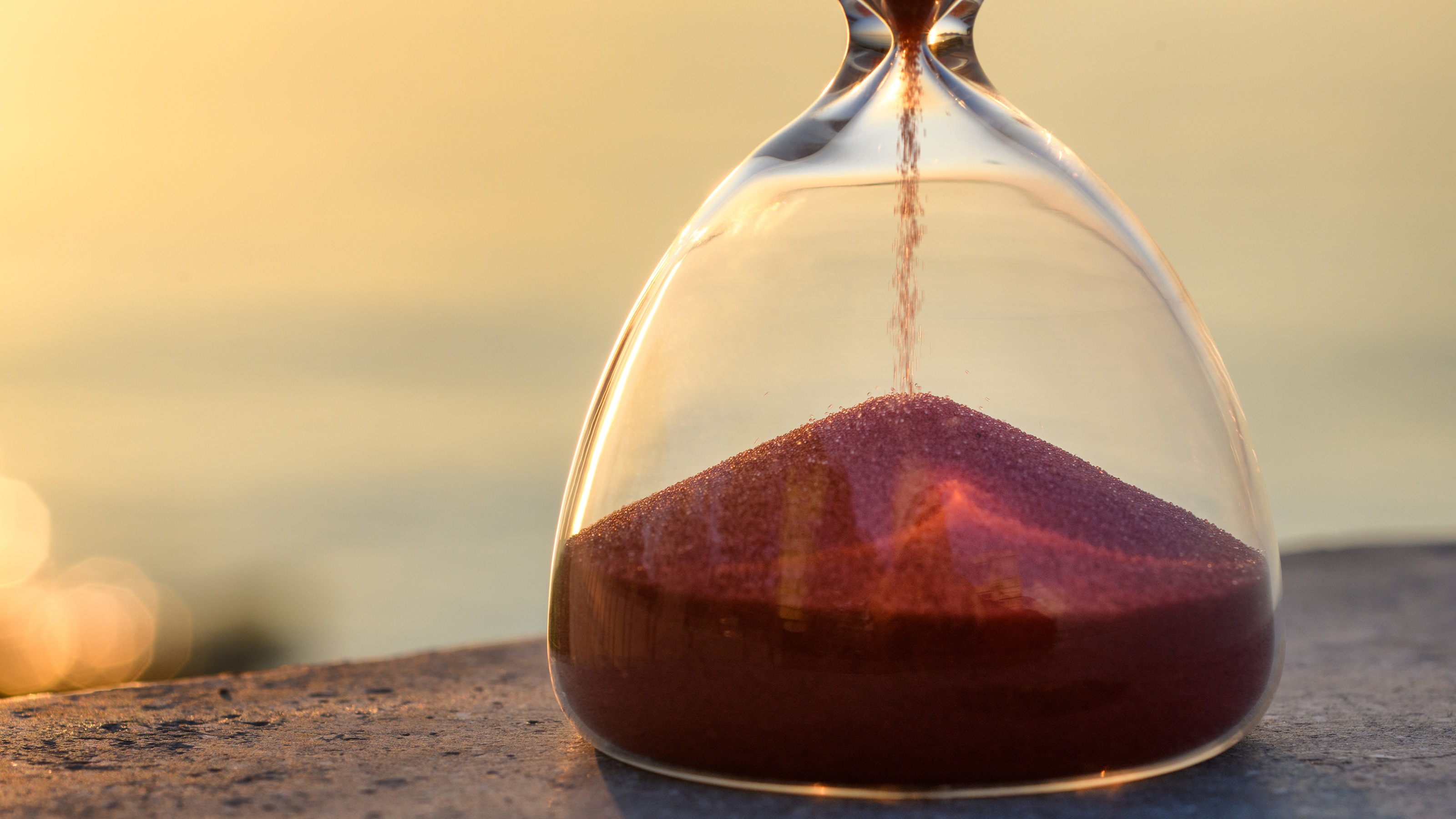 Sound flowing into the bottom of an hourglass.