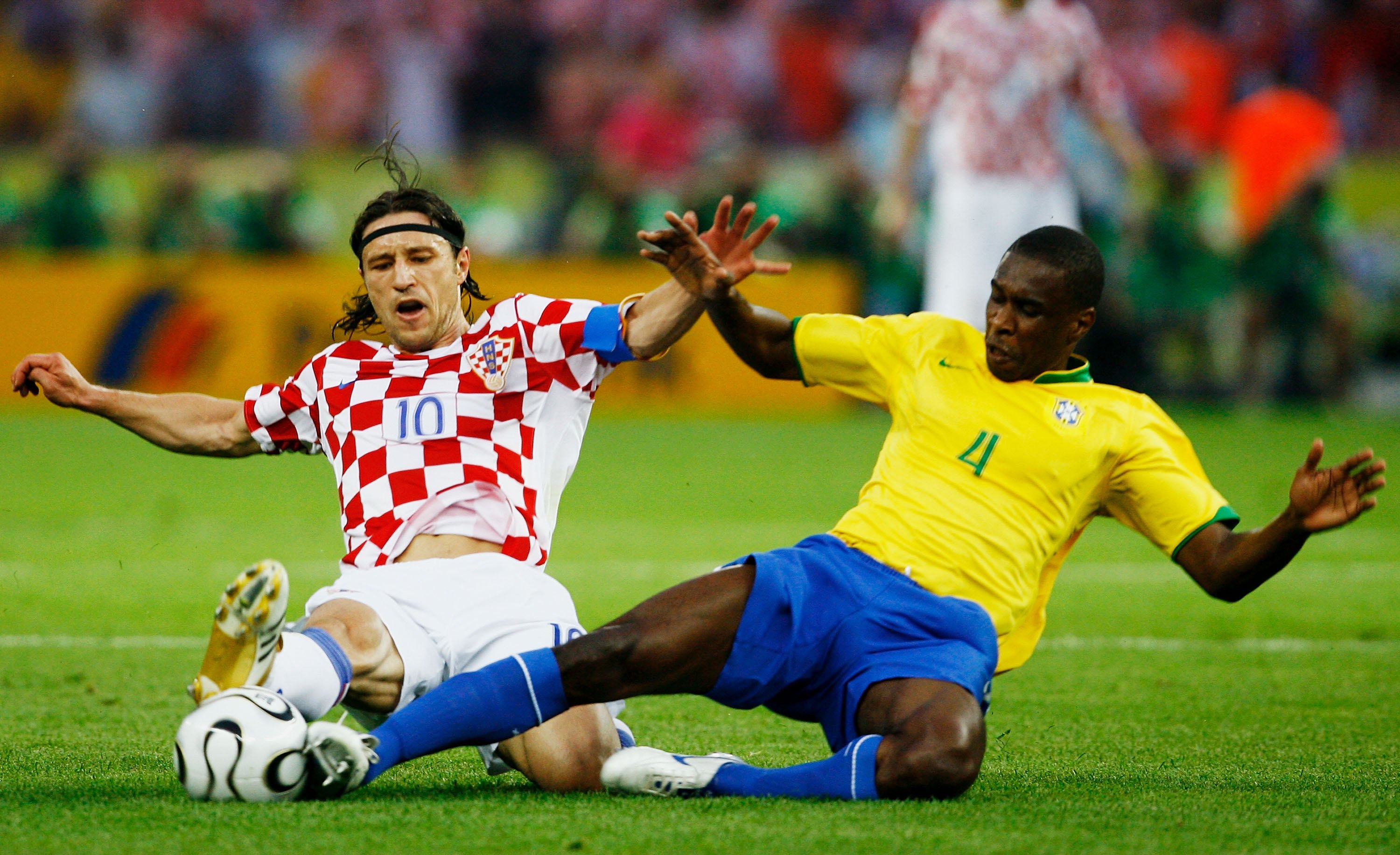 Croatia's Niko Kovac and Brazil's Juan slide in to dispute a ball at the 2010 World Cup.