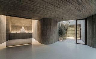 indoor Buddhist shrine with natural wooden plank interior design