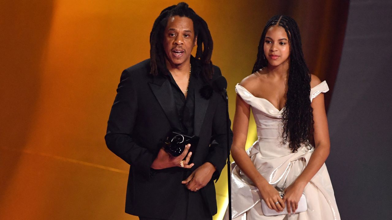 US rapper Jay-Z (L) accepts the Dr. Dre Global Impact Award alongside his daughter Blue Ivy on stage during the 66th Annual Grammy Awards