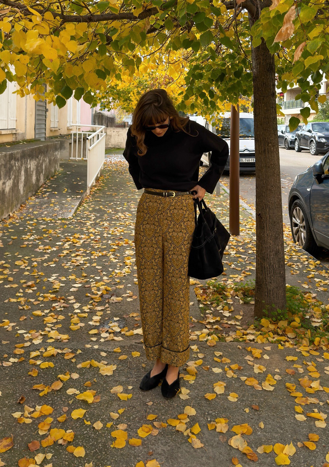 Influencer wearing a black turtleneck and brocade pants