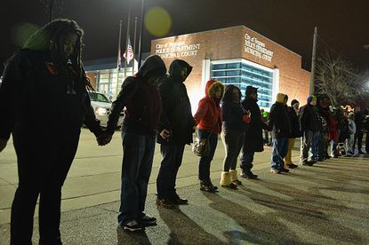 Protesters demonstrate outside the Ferguson police headquarters