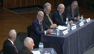 Buzz Aldrin, Karol Bobko, Vance Brand and Walter Cunningham sit on a panel at MIT.