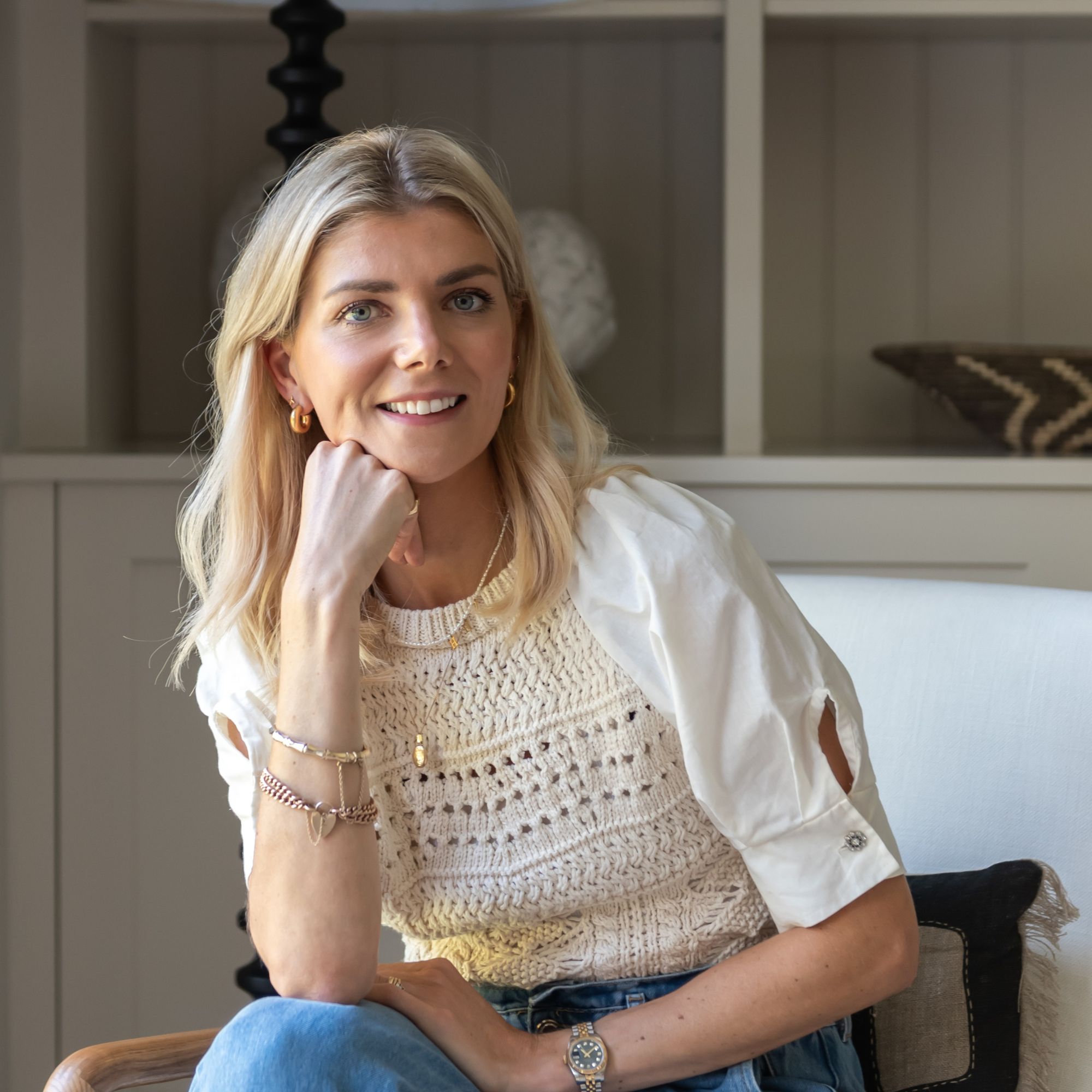 blonde woman in crochet top smiling at camera