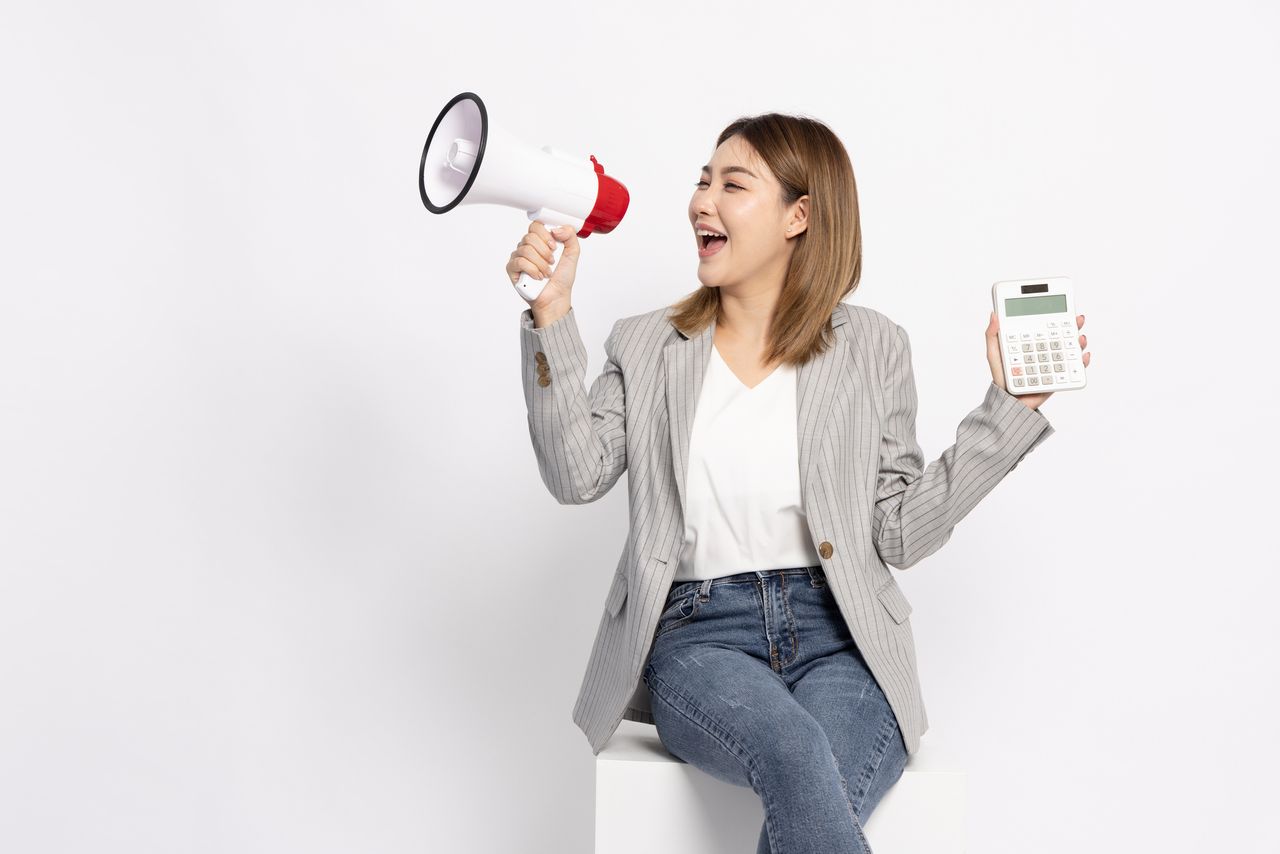 Woman holding calculator and megaphone isolated on white background