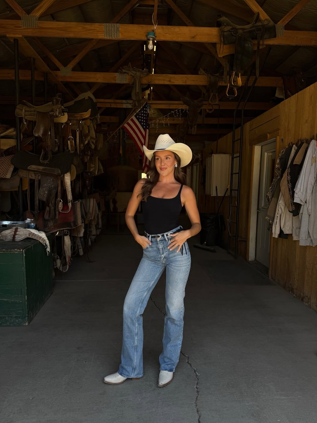 emma leger wearing light wash jeans and cowboy boots