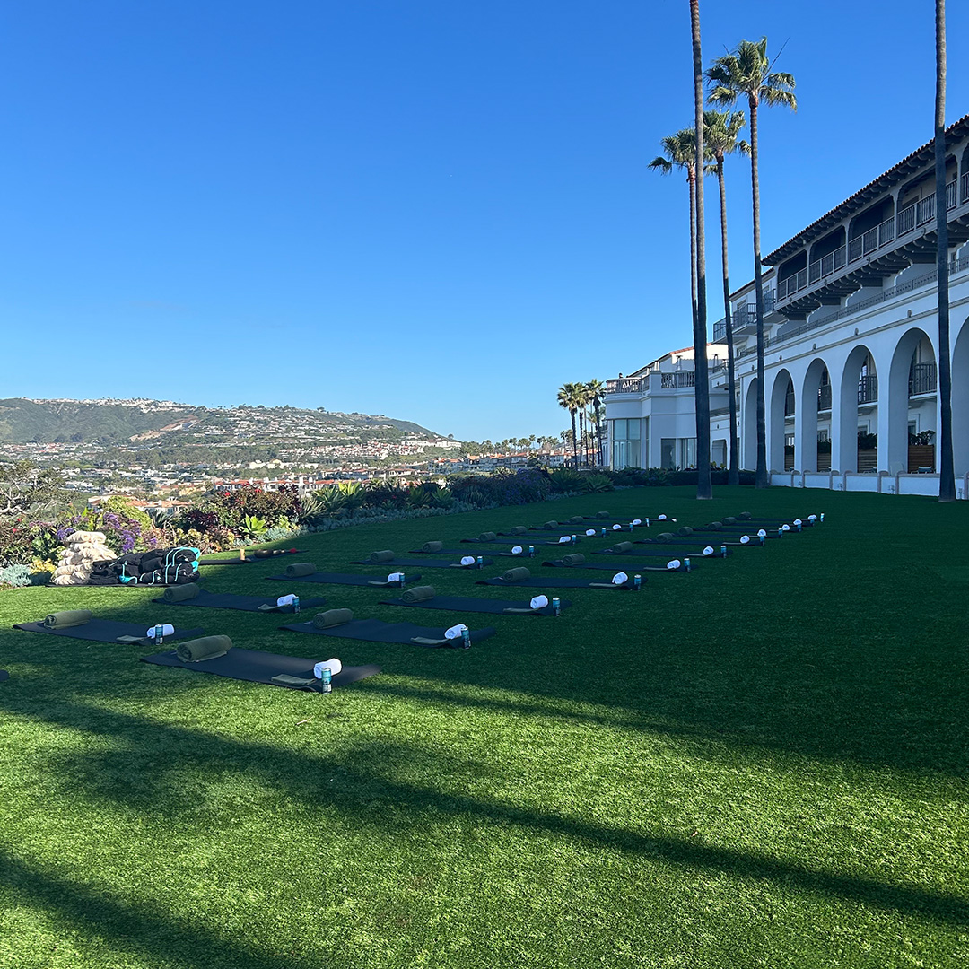 The bluffs at the Ritz-Carlton Laguna Niguel Hotel. A bunch of yoga mats are laid out on a sprawling lawn.
