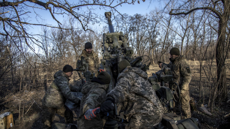 Ukrainian soldiers load a cannon near Bakhmut