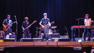 A photograph of The Jayhawks on stage