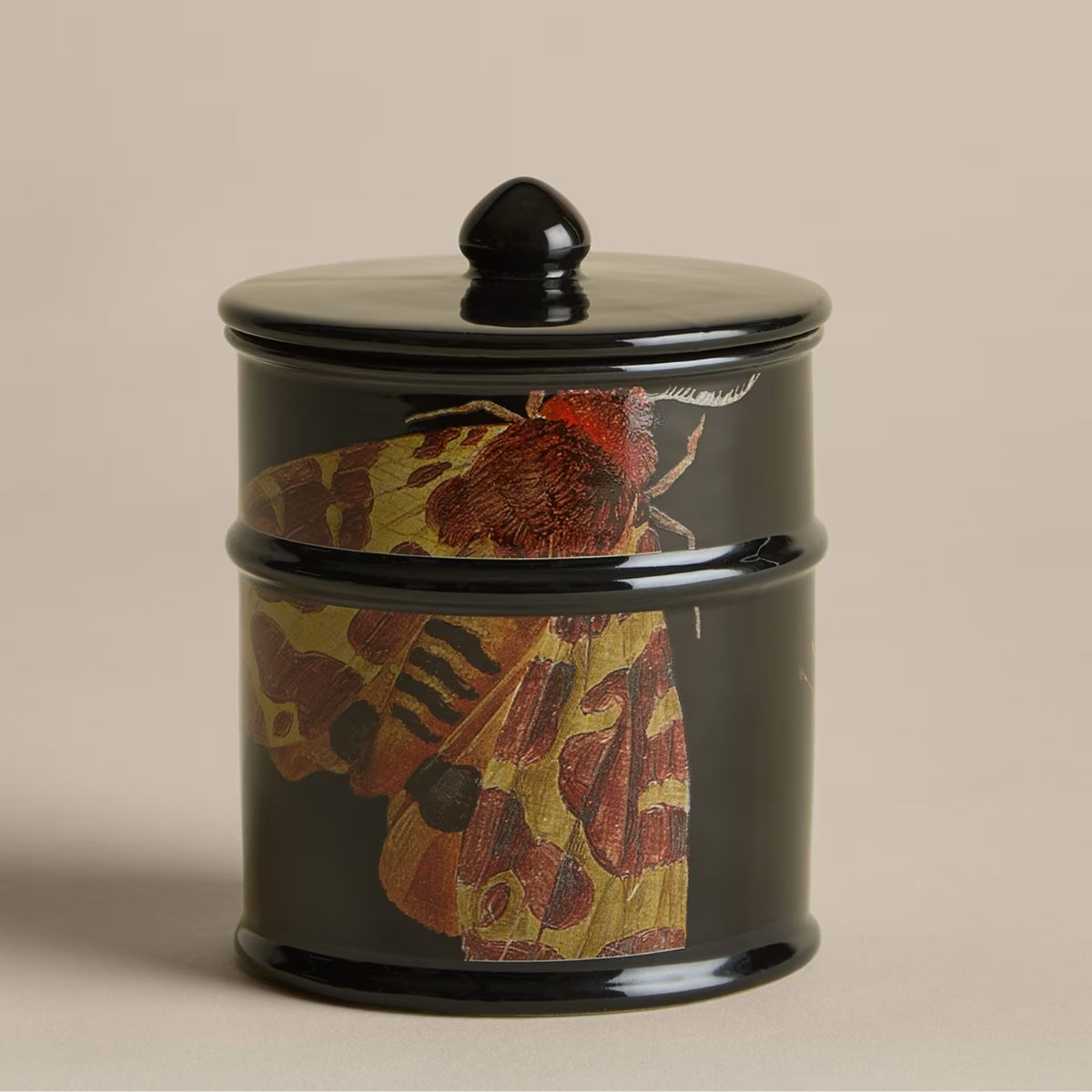 Black candle with butterfly motif