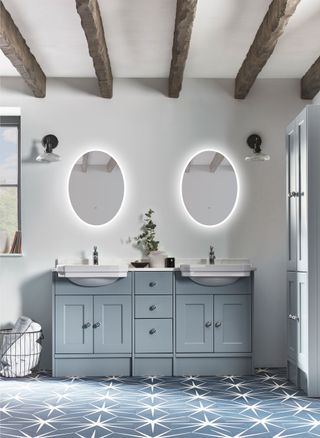 blue bathroom with blue shaker vanity, blue patterned floor tiles, exposed beams