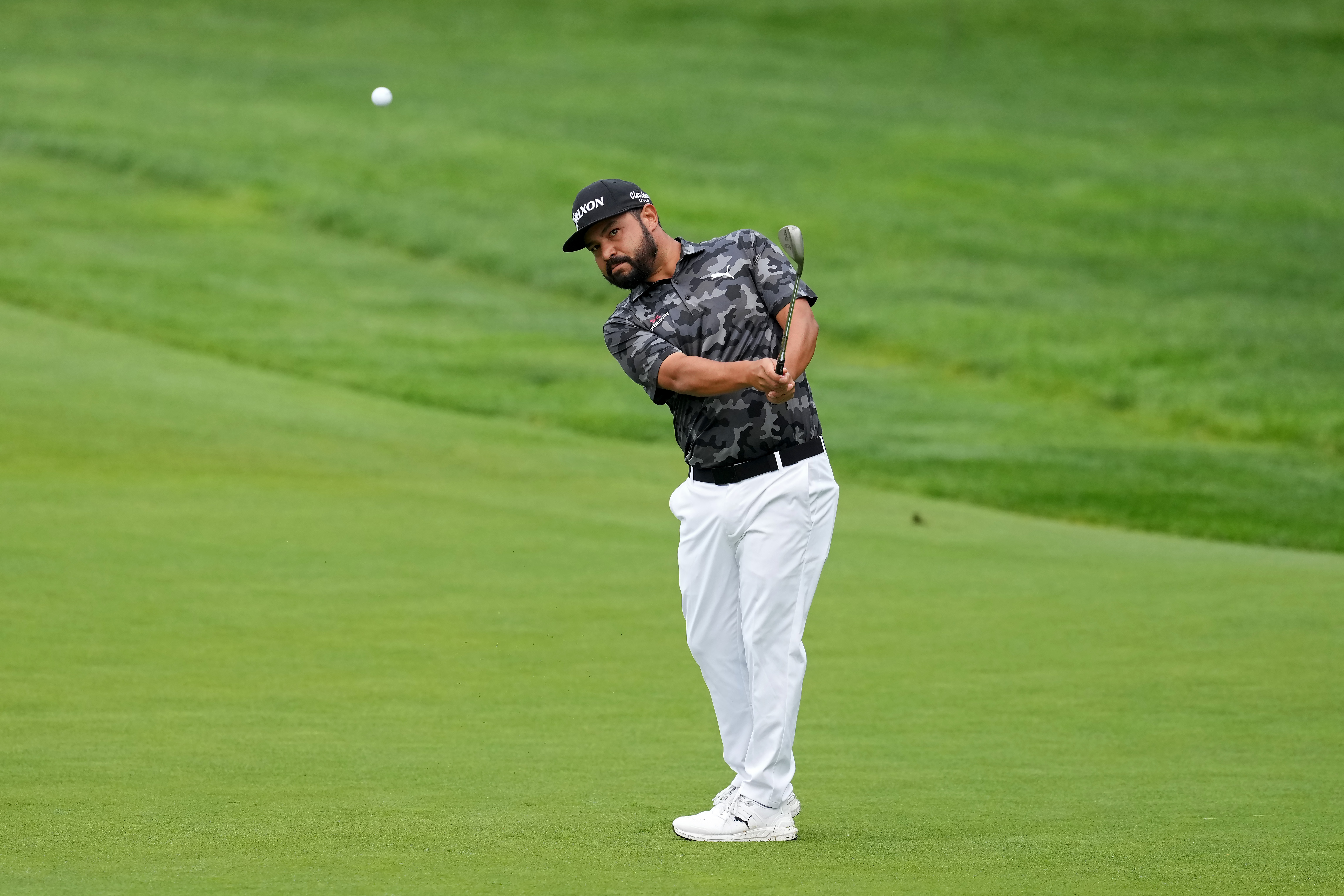 J.J Spaun hits a wedge shot from the fairway