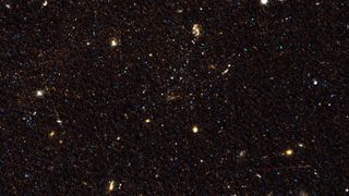 Pictured is one of the three galaxies, Scl-MM-dw5, with its stars clustered at center.