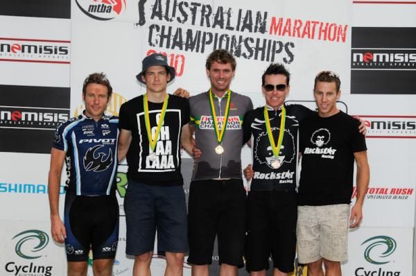 The top five riders in the men's category pose on the podium.
