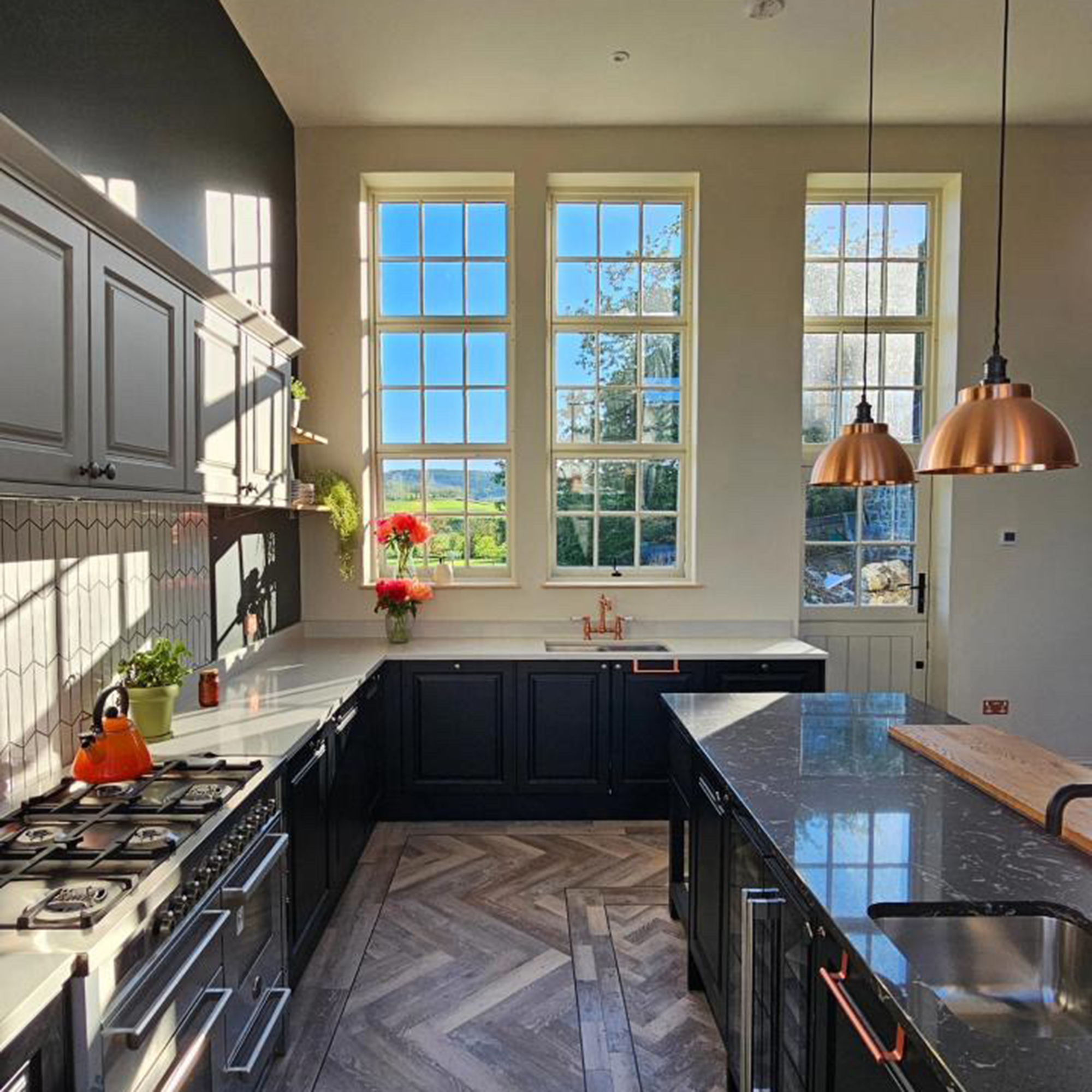 large kitchen with black central island and black cabinets