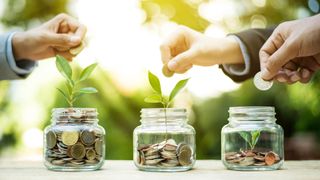 People in suits adding money to jars growing plants