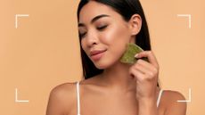 how to use gua sha image of a woman holding gua sha tool to her neck