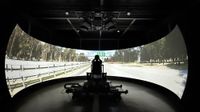 Vector Simulations driving simulator with a massive display making it look like a man is driving the open road.