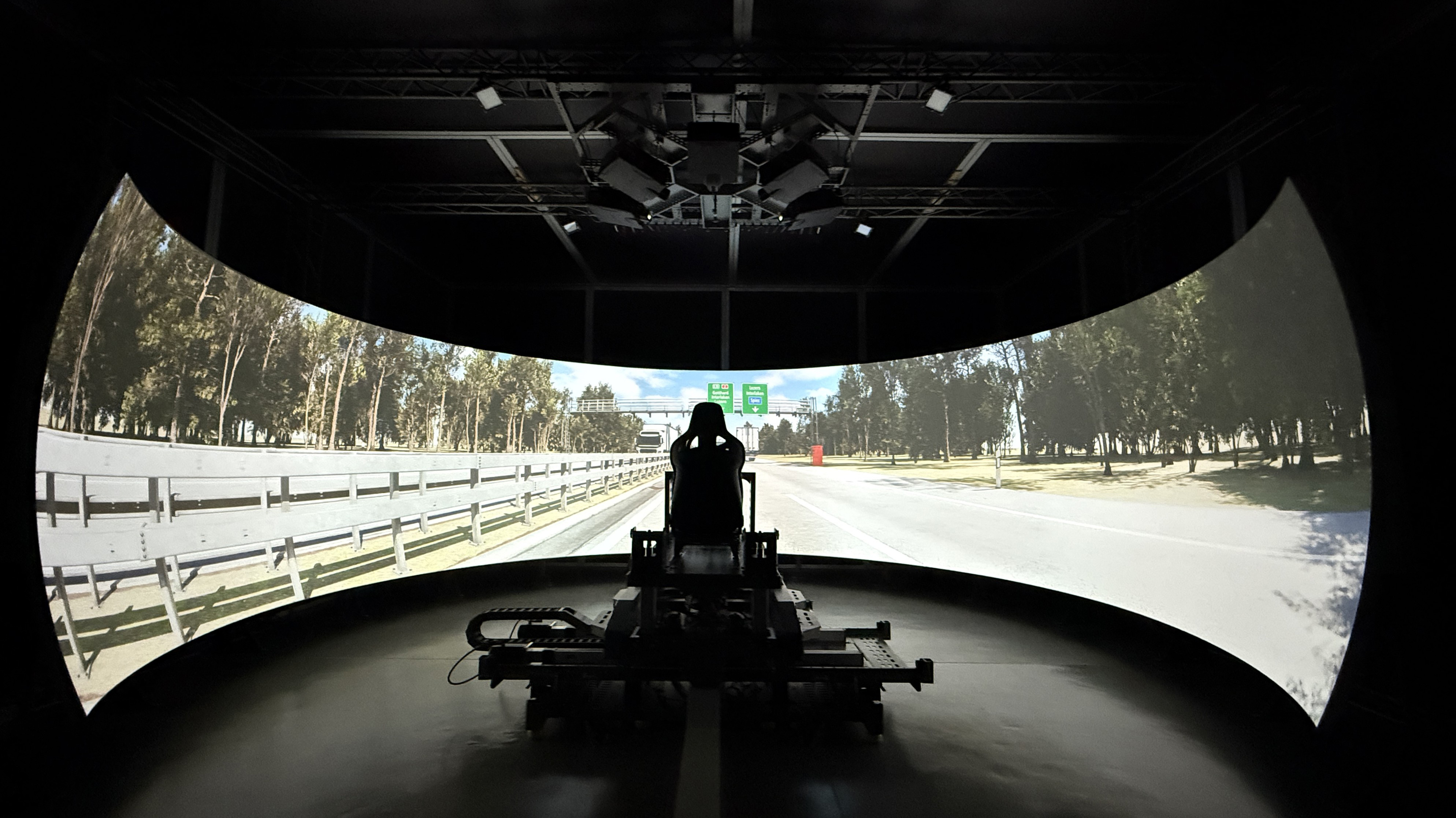Vector Simulations driving simulator with a massive display making it look like a man is driving the open road. 