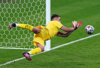 Gianluigi Donnarumma saves from Bukayo Saka