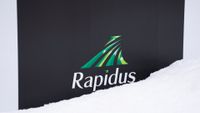The logo of Rapidus, a Japanese semiconductor manufacturer, covered in snow outside company's semiconductor manufacturing plant