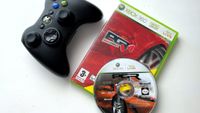 A black Xbox 360 controller next to the red cover of the video game "Project Gotham Racing 4" and a silver disc with a racing car design.