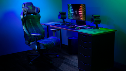 The Razer Project Carol attached to a gaming chair in a room lit with multicolour RGB lights