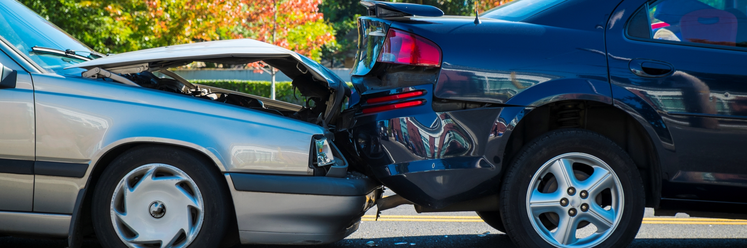 Two damaged cars after a fender bender car accident.