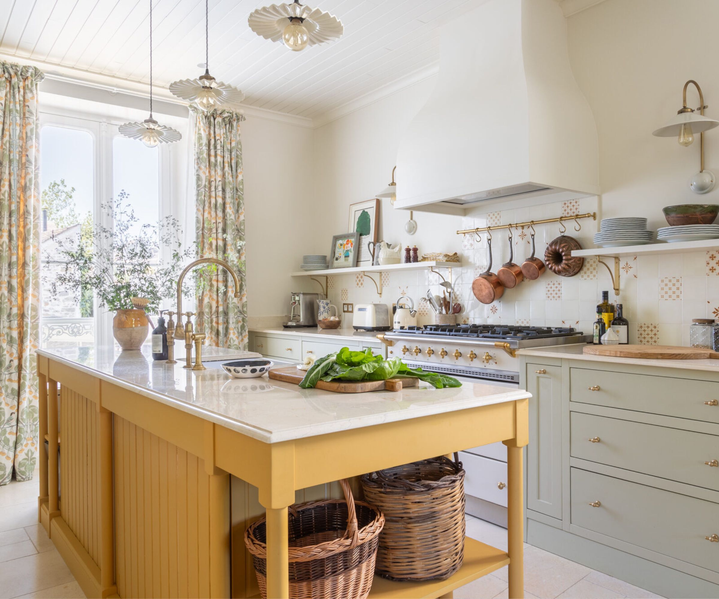 A traditional kitchen with blue cabinets and a yellow island designed with a mix of open and closed storage