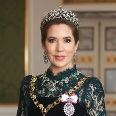 Queen Mary wearing a tiara and green lace dress