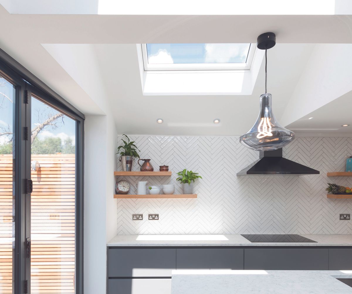 a contemporary pitched roof kitchen extension with skylights causing a feeling of brightess and openess