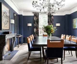 Dining room with navy walls and leather chairs