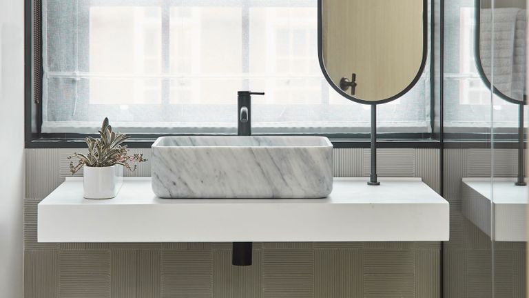 a modern bathroom with a basin in front of a winow