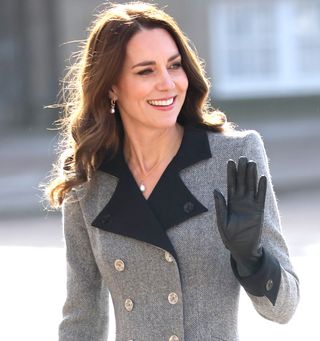 Catherine, Duchess of Cambridge waves as she accompanies Mary, Crown Princess of Denmark during a visit Christian IX's Palace
