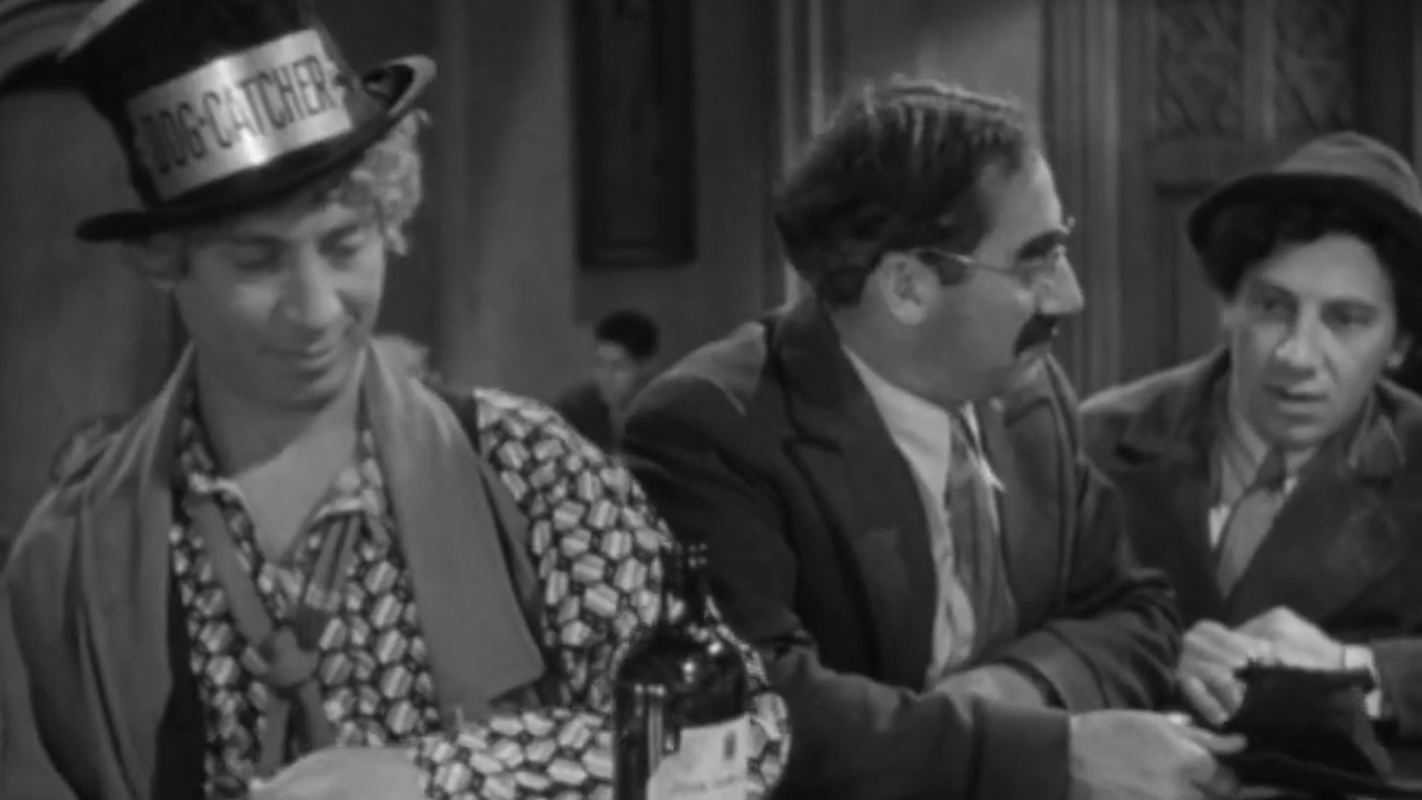 Three of the Marx brothers sitting at a bar.