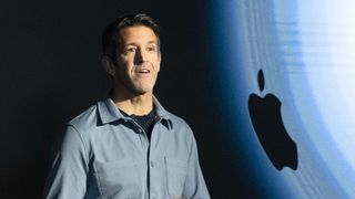 John Ternus in front of the Apple logo