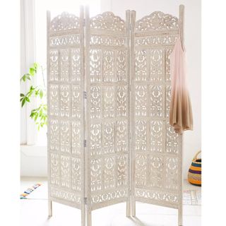 white folding screen with carved pattern