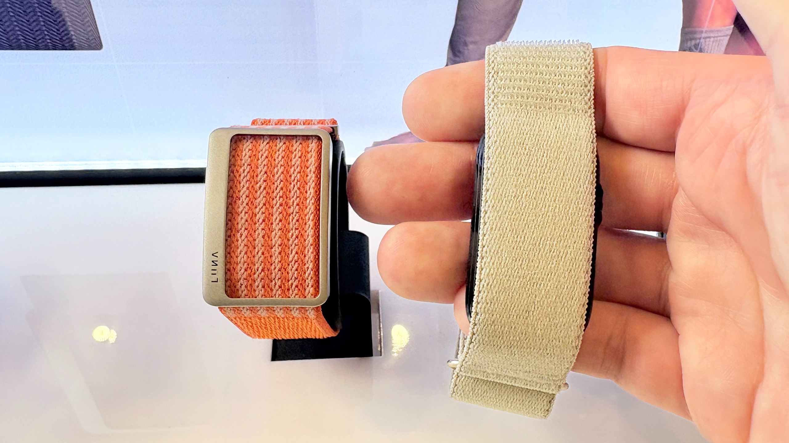 Close-up of the Garmin Cirqa screen-free tracker next to the Luna Band at IFA 2026 in Berlin
