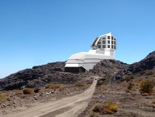 An artist's rendering of the Large Synoptic Survey Telescope superimposed on a photograph of its site in Chile.