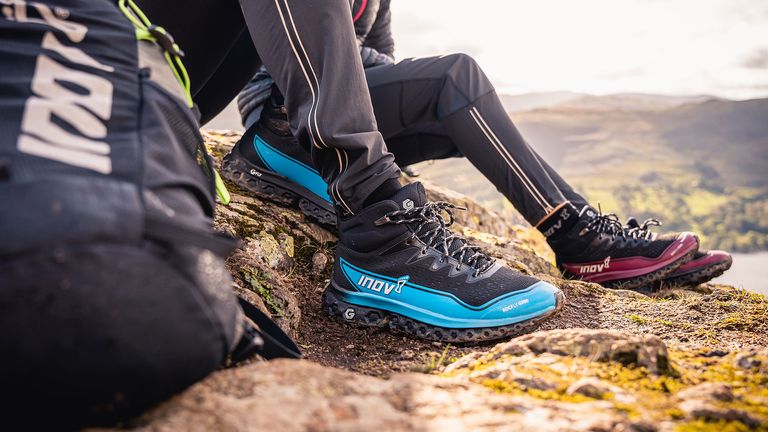 Couple wearing Inov-8 Rocfly G 390 hiking boots while walking in the hills