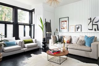 a modern living room with wall paneling and a black painted floor