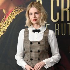 Lucy Boynton wears a plaid vest