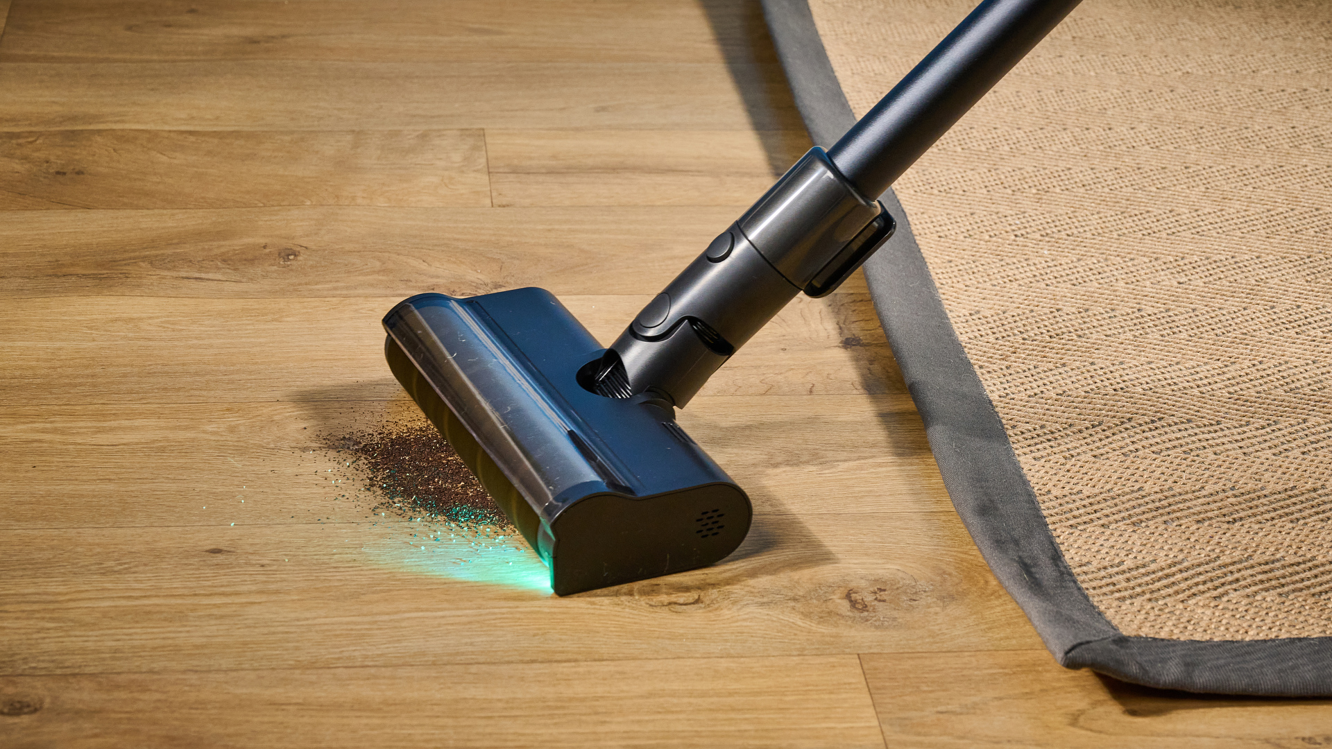 The Dreame Z30 in hand being used to vacuum with its green detection lamp