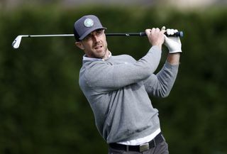 Alex Smith hits a shot from the fairway with an iron