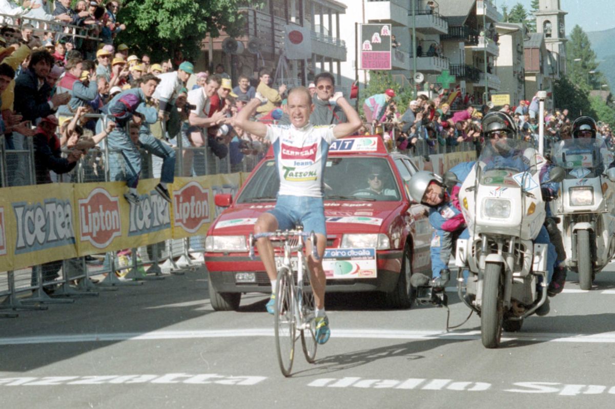 Pantani raises his arms as he crosses the line